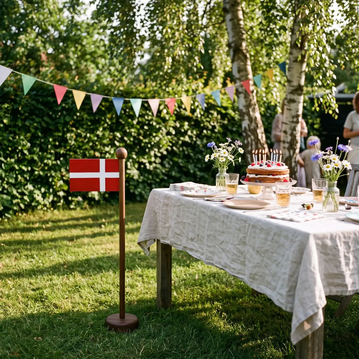 Danish Flag on Amberwood Pole next to a garden birthday table